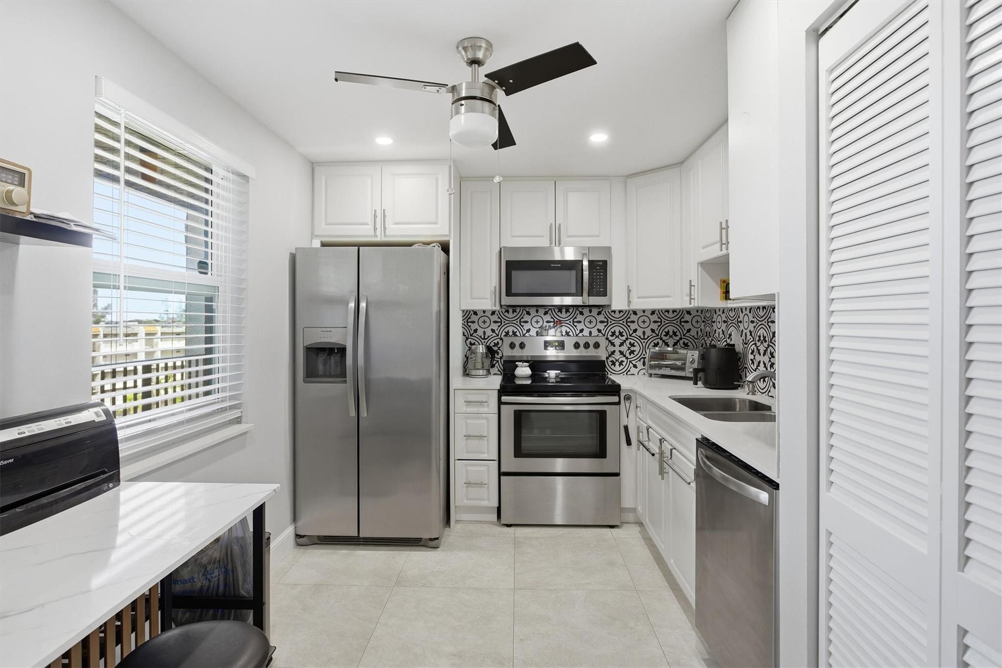 3910 Inverrary Boulevard, Unit 708B Lauderhill, FL 33319 - Photo 14 of 58 a kitchen with kitchen island a counter top space stainless steel appliances and cabinets