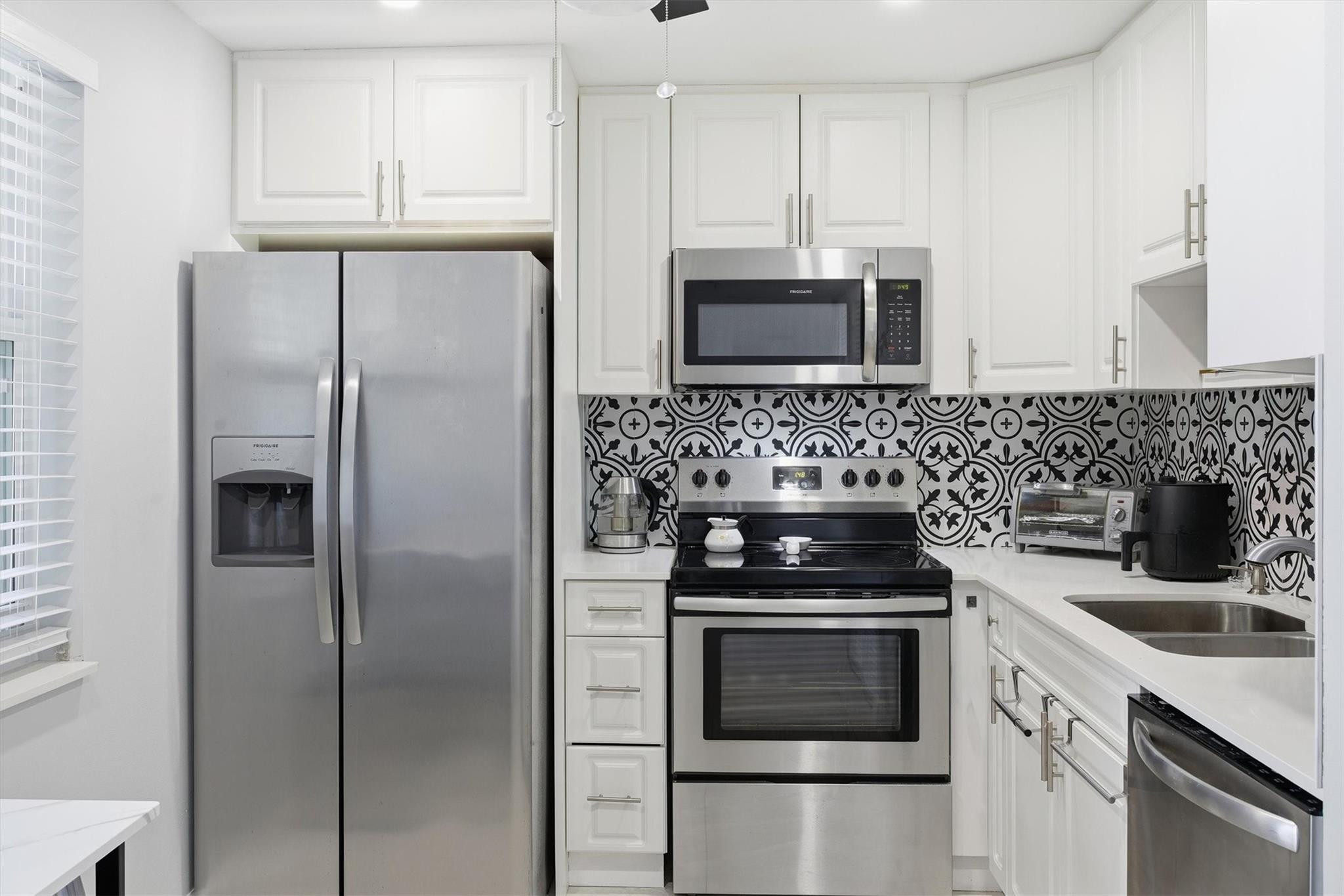 3910 Inverrary Boulevard, Unit 708B Lauderhill, FL 33319 - Photo 15 of 58 a kitchen with cabinets stainless steel appliances and a counter space