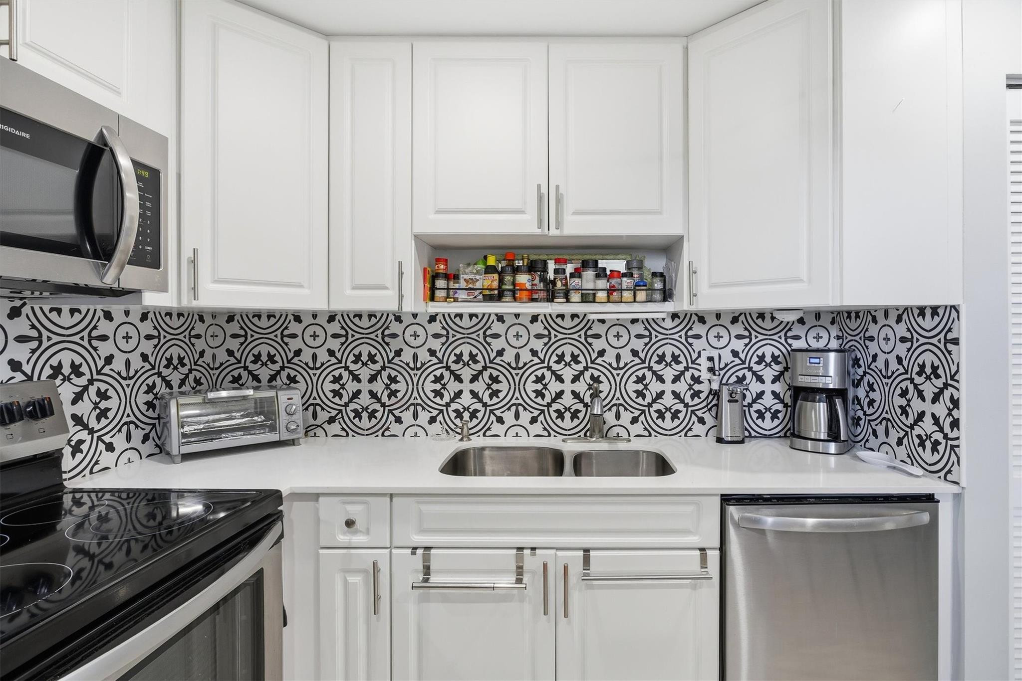 3910 Inverrary Boulevard, Unit 708B Lauderhill, FL 33319 - Photo 16 of 58 a kitchen with appliances a sink and cabinets