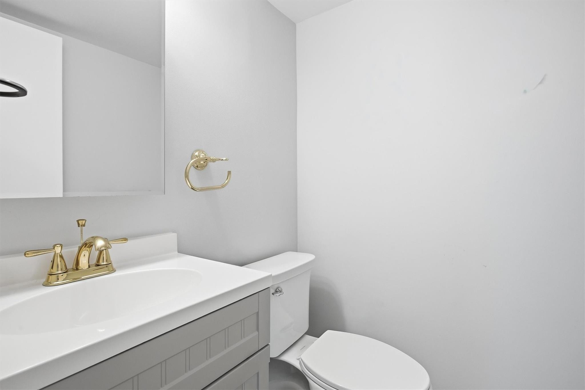 3910 Inverrary Boulevard, Unit 708B Lauderhill, FL 33319 - Photo 31 of 58 a bathroom with a granite countertop toilet and sink