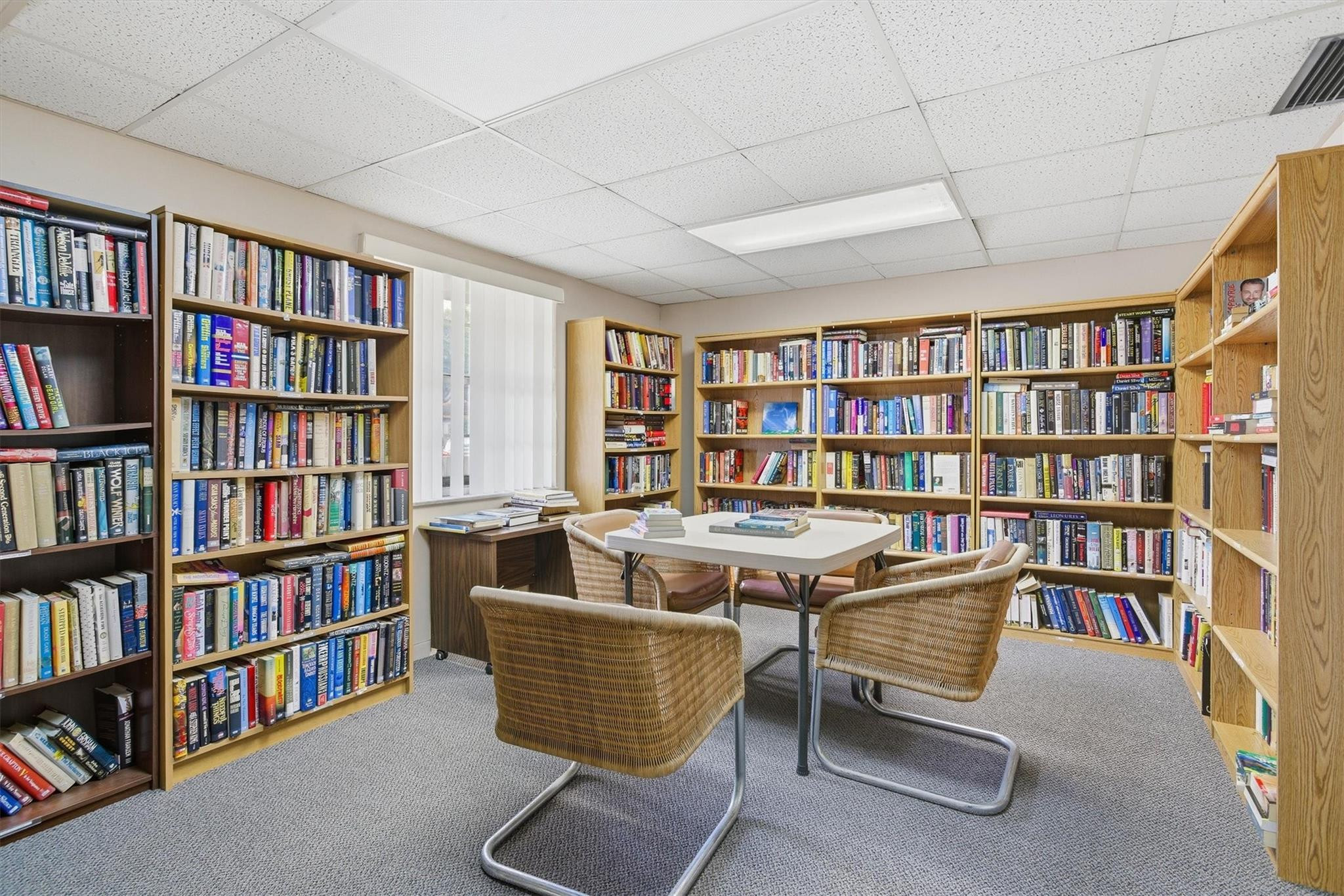 3910 Inverrary Boulevard, Unit 708B Lauderhill, FL 33319 - Photo 39 of 58 a living room with a book shelf and a book shelf