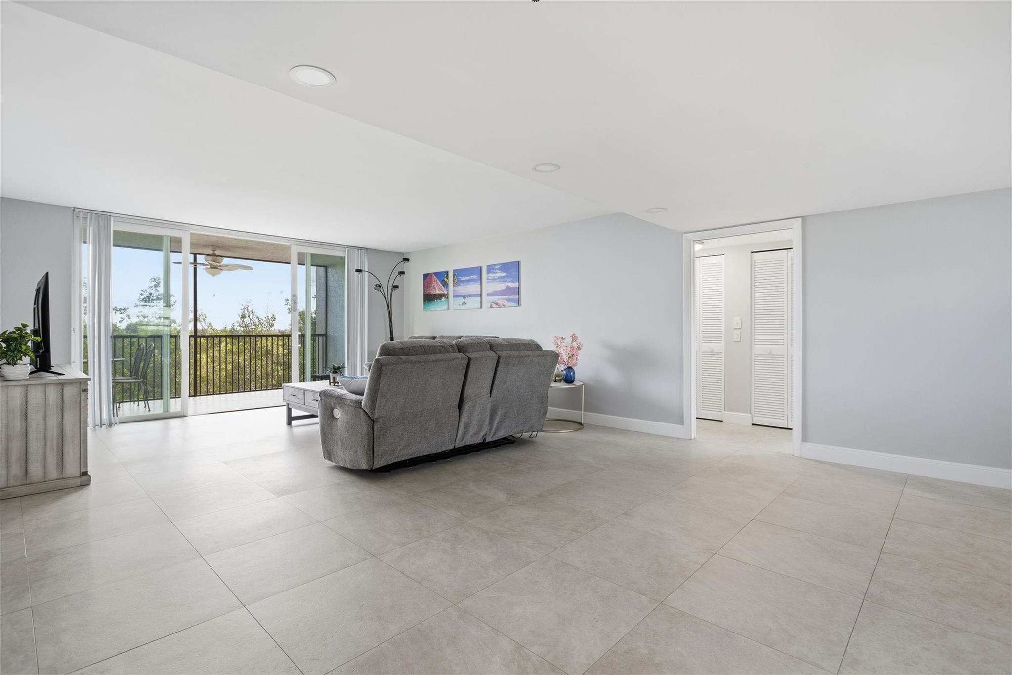 3910 Inverrary Boulevard, Unit 708B Lauderhill, FL 33319 - Photo 5 of 58 a spacious bedroom with a bed and large window