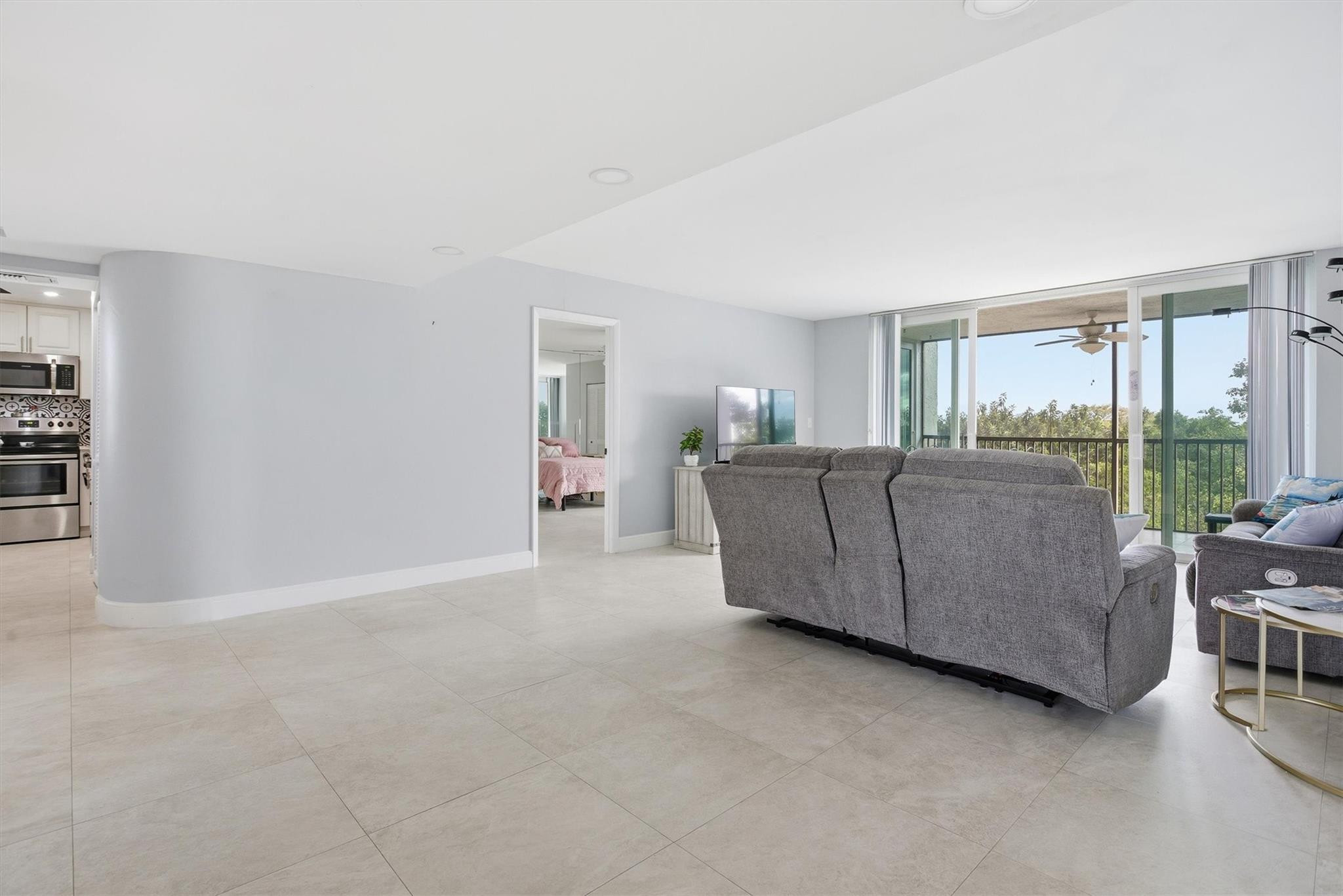 3910 Inverrary Boulevard, Unit 708B Lauderhill, FL 33319 - Photo 6 of 58 a living room with furniture and a large window