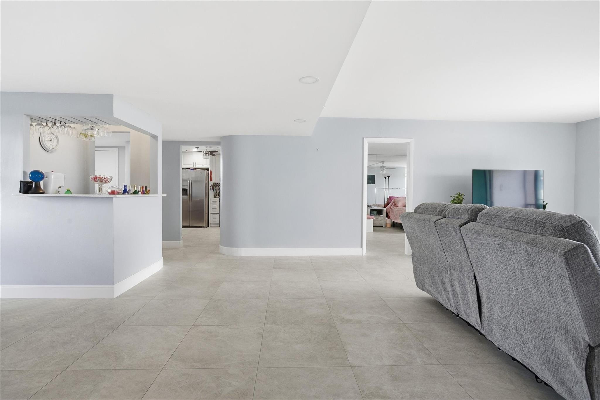 3910 Inverrary Boulevard, Unit 708B Lauderhill, FL 33319 - Photo 7 of 58 a living room with furniture and a wooden floor