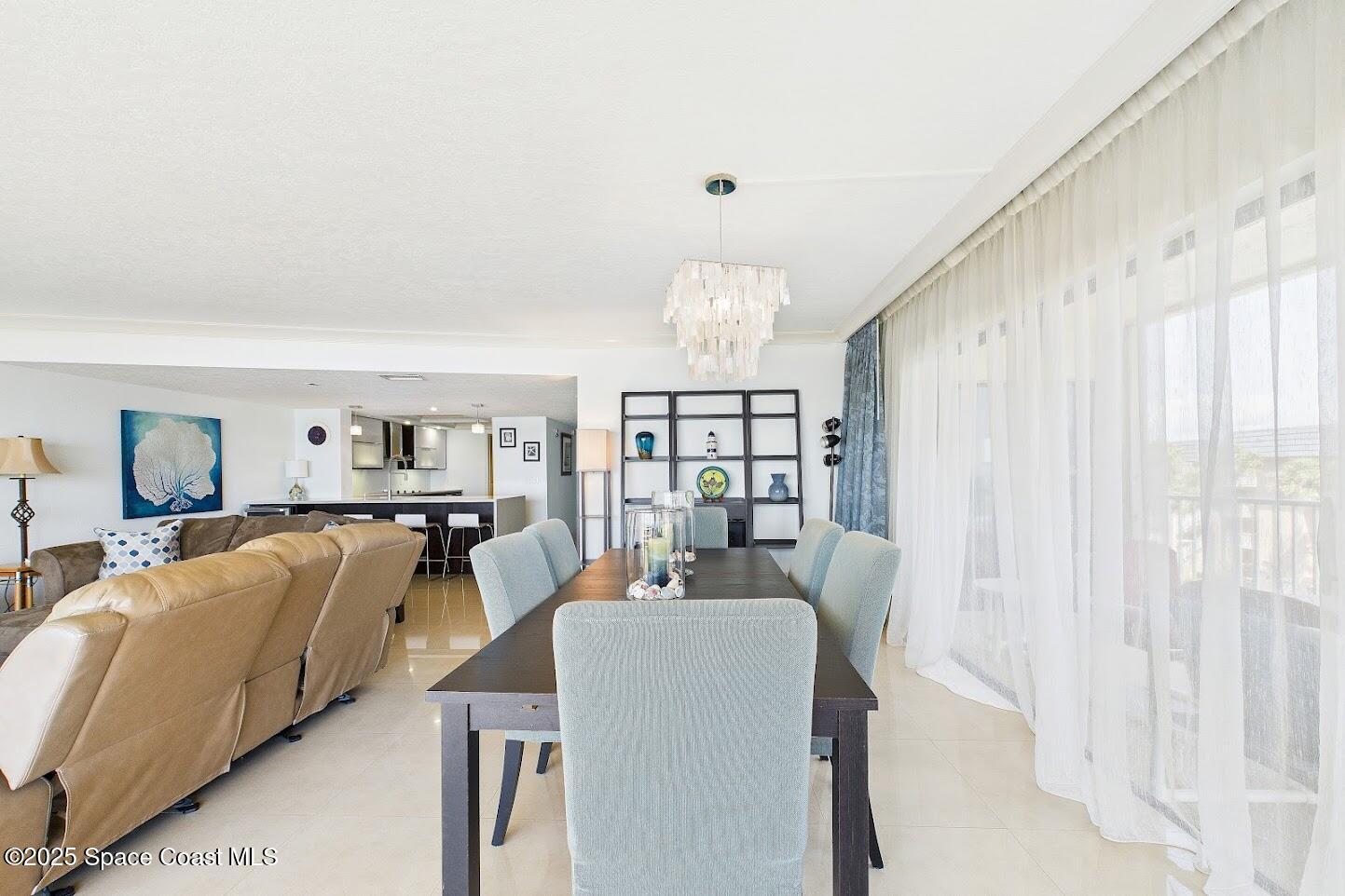 55 North 4th Street, Unit 401 Cocoa Beach, FL 32931 - Photo 14 of 34 a living room with furniture and a flat screen tv