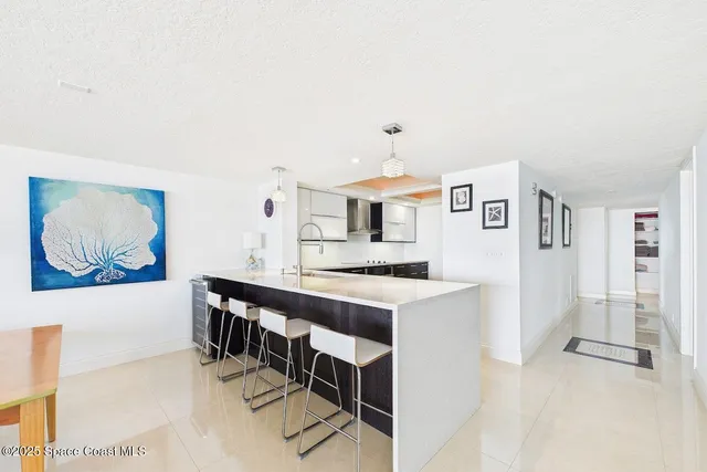 a kitchen with stainless steel appliances a stove a refrigerator and a cabinets