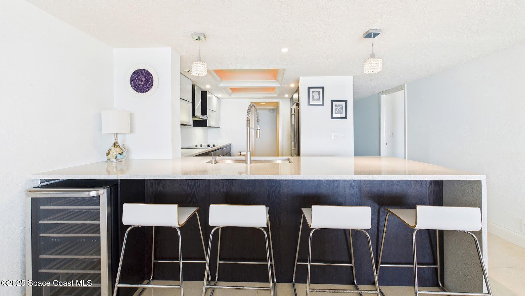 55 North 4th Street, Unit 401 Cocoa Beach, FL 32931 - Photo 16 of 34 a bathroom with a sink a mirror and shower