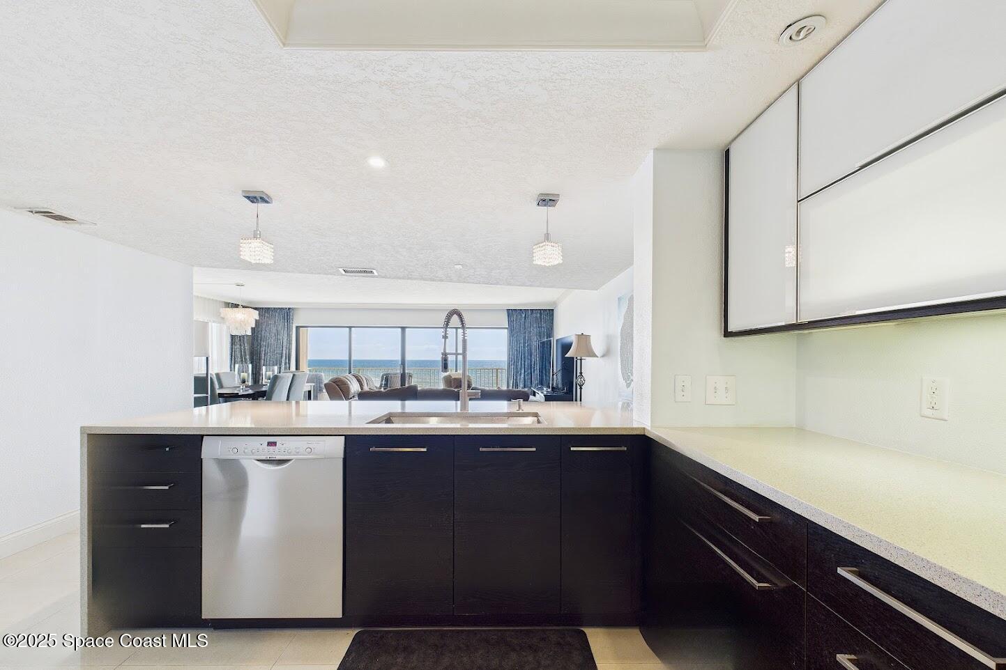 55 North 4th Street, Unit 401 Cocoa Beach, FL 32931 - Photo 17 of 34 a kitchen with stainless steel appliances granite countertop a sink stove and cabinets
