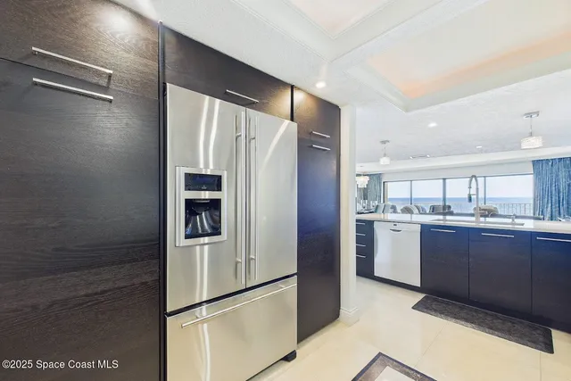 a kitchen with stainless steel appliances granite countertop a refrigerator and a sink