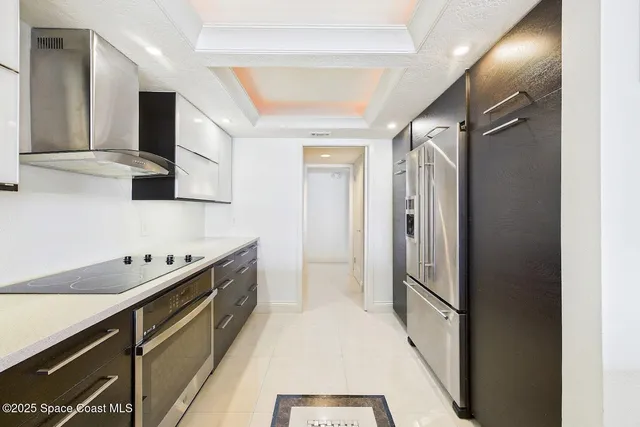 a kitchen with stainless steel appliances a refrigerator and a sink