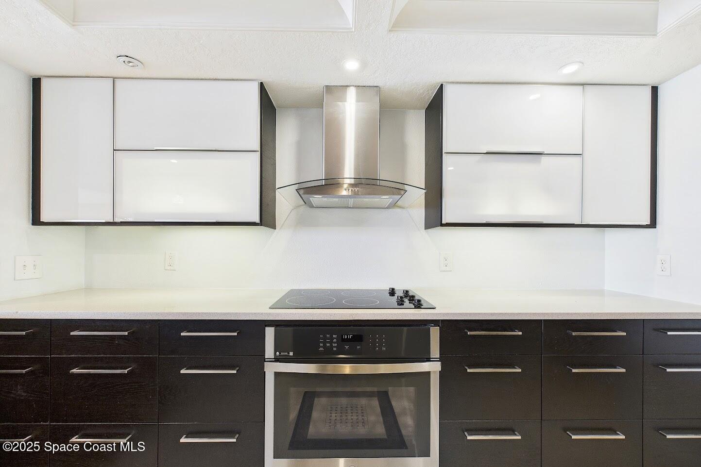 55 North 4th Street, Unit 401 Cocoa Beach, FL 32931 - Photo 22 of 34 a kitchen with a sink and cabinets