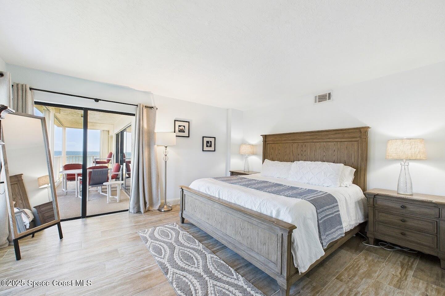 55 North 4th Street, Unit 401 Cocoa Beach, FL 32931 - Photo 24 of 34 a bedroom with a large bed and a large window