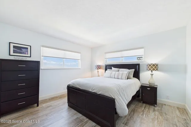 a bedroom with a bed and a night stand