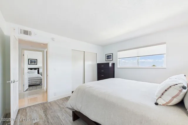 a bedroom with a bed and a view of bathroom