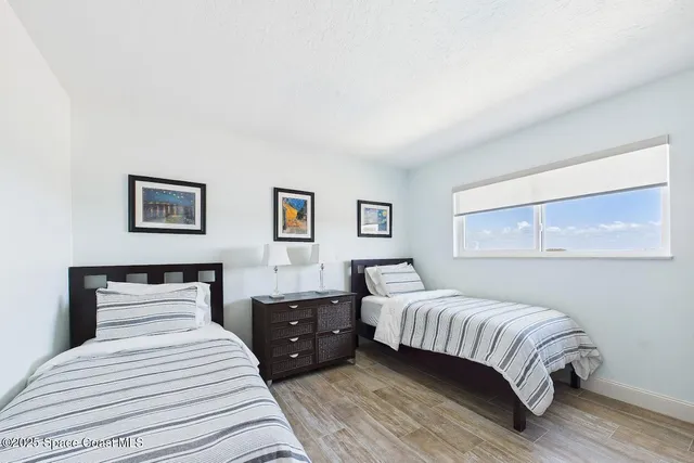 a bedroom with a bed and a night stand