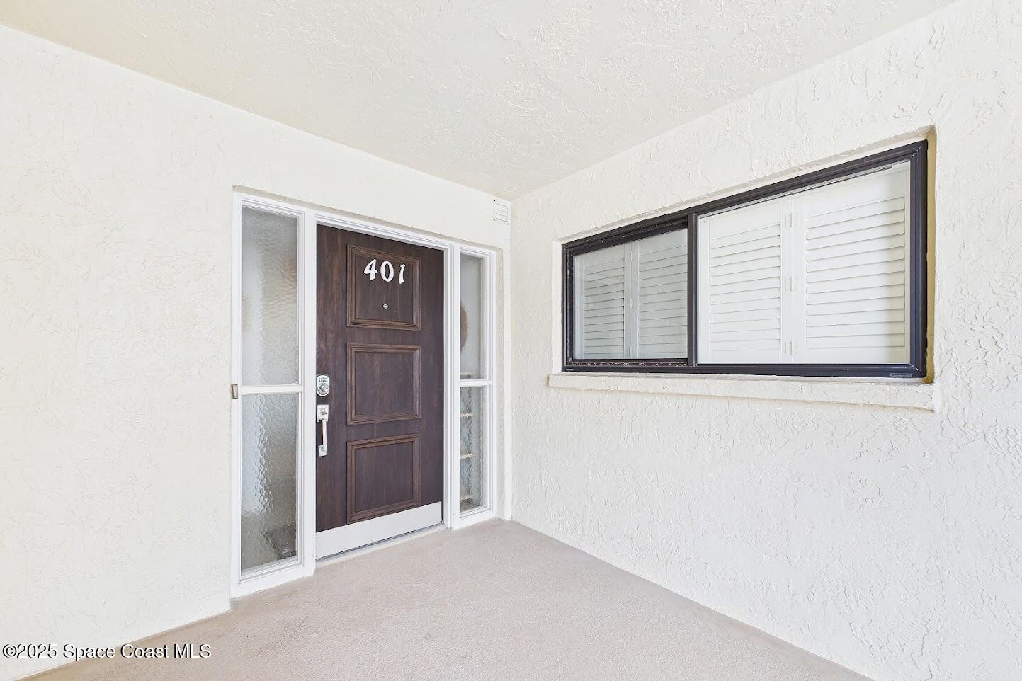 55 North 4th Street, Unit 401 Cocoa Beach, FL 32931 - Photo 4 of 34 a view of an empty room with closet and a window