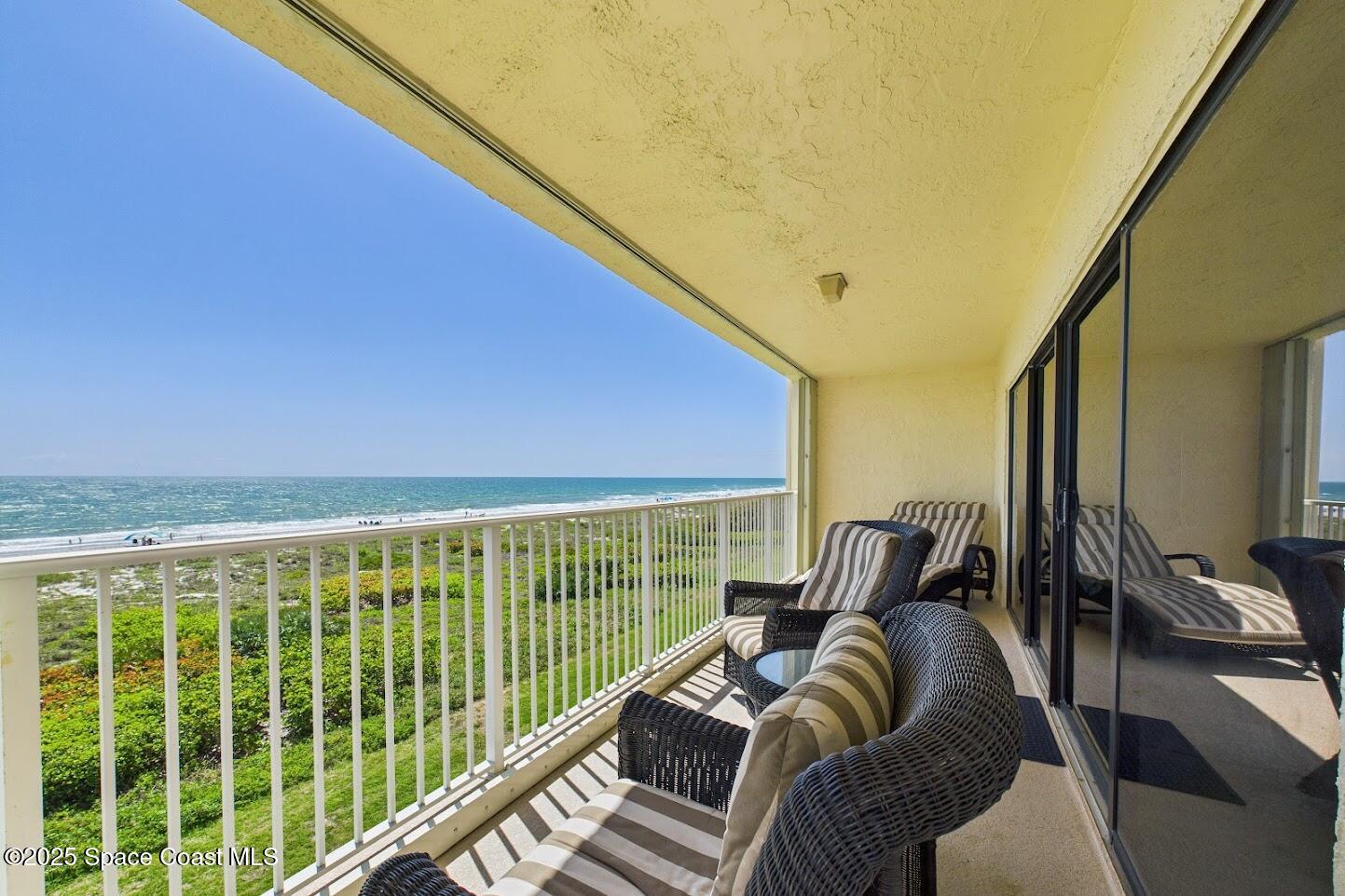 55 North 4th Street, Unit 401 Cocoa Beach, FL 32931 - Photo 5 of 34 a bedroom with furniture and a large window