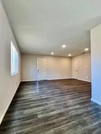 a view of a room with wooden floor