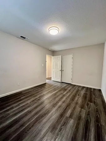 a view of an empty room and wooden floor