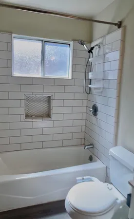 a bathroom with a toilet and a shower