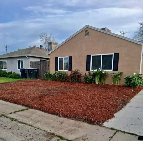 a front view of a house with garden
