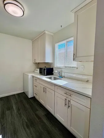 a kitchen with sink cabinets and window