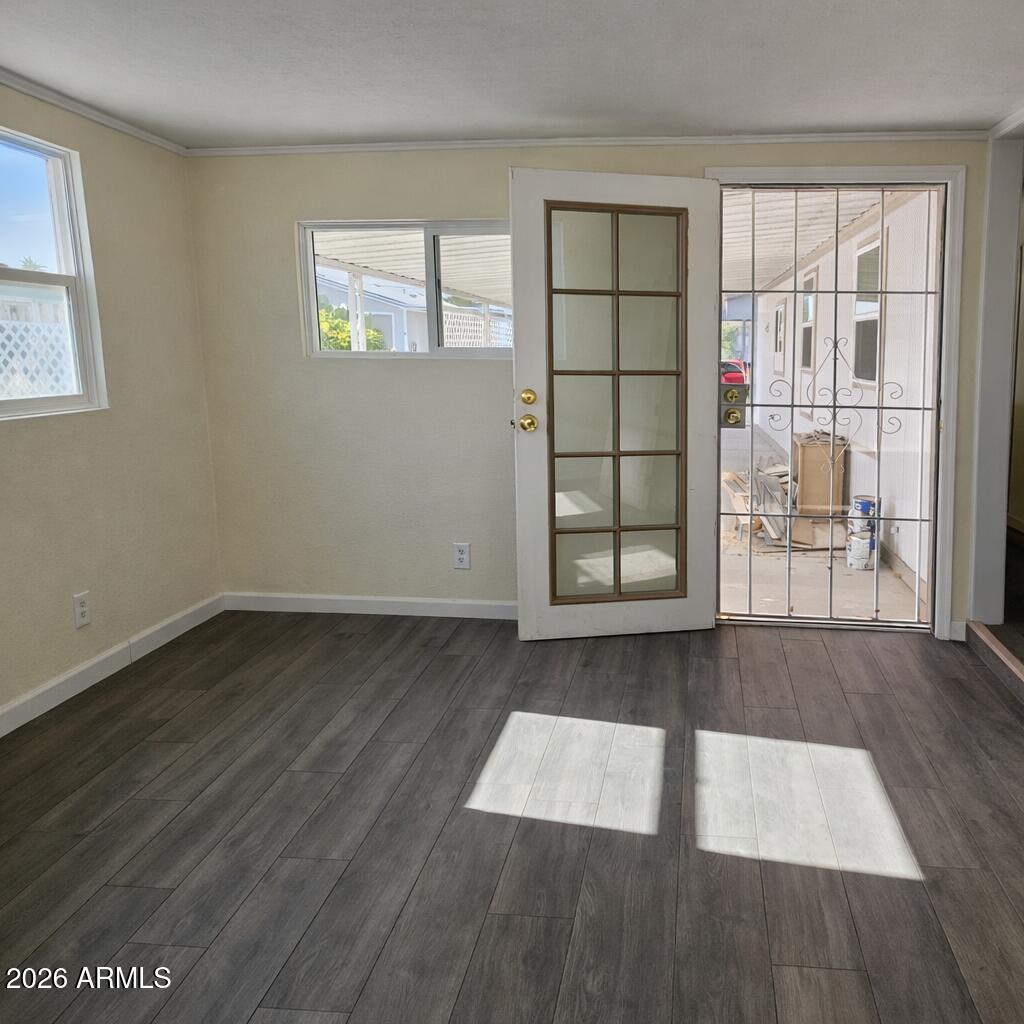 3405 South Tomahawk Road, Unit 301 Apache Junction, AZ 85119 - Photo 8 of 10 an empty room with wooden floor and windows