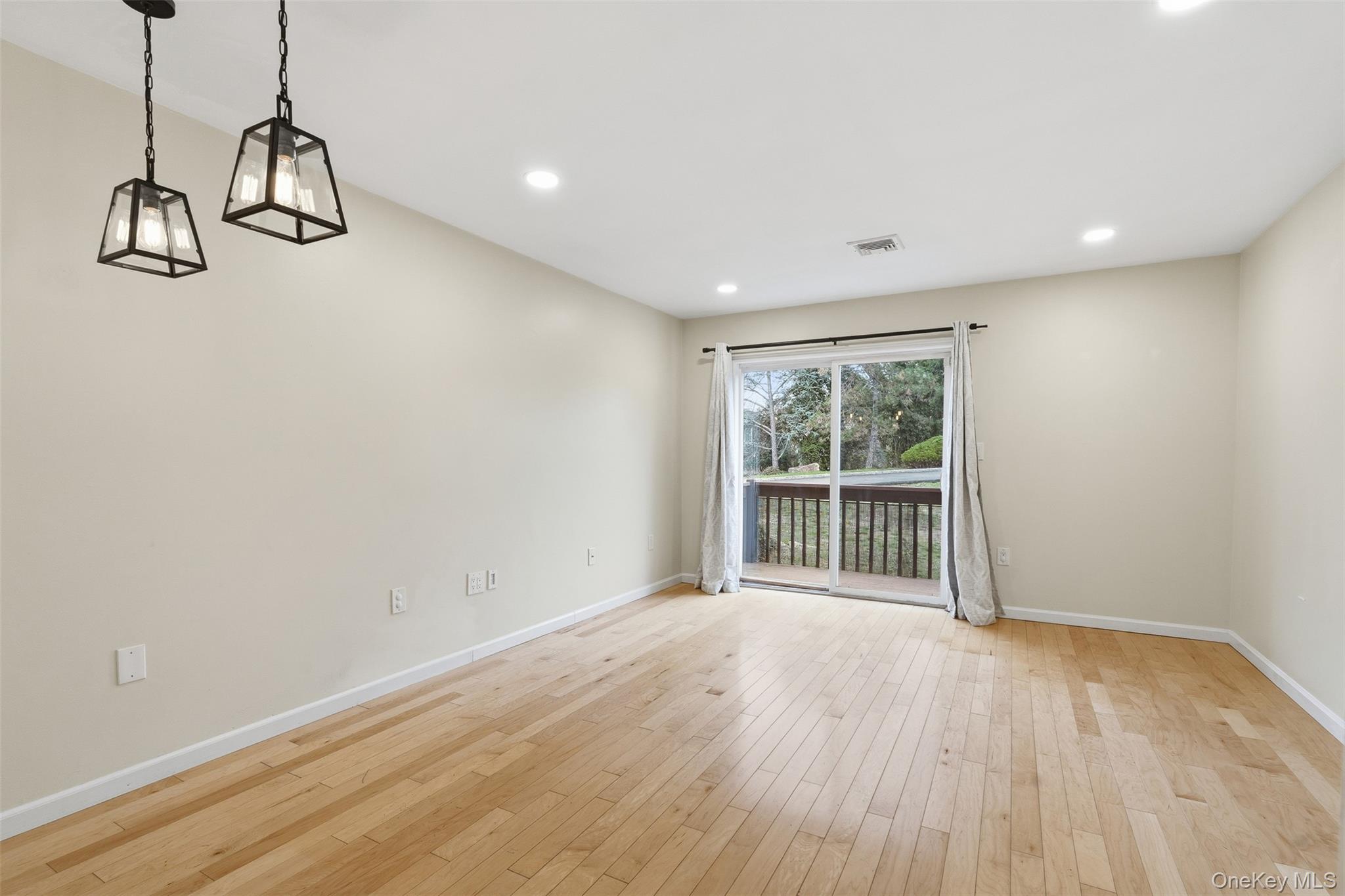 17 Knoll View Ossining, NY 10562 - Photo 12 of 34 a view of an empty room with wooden floor and windows