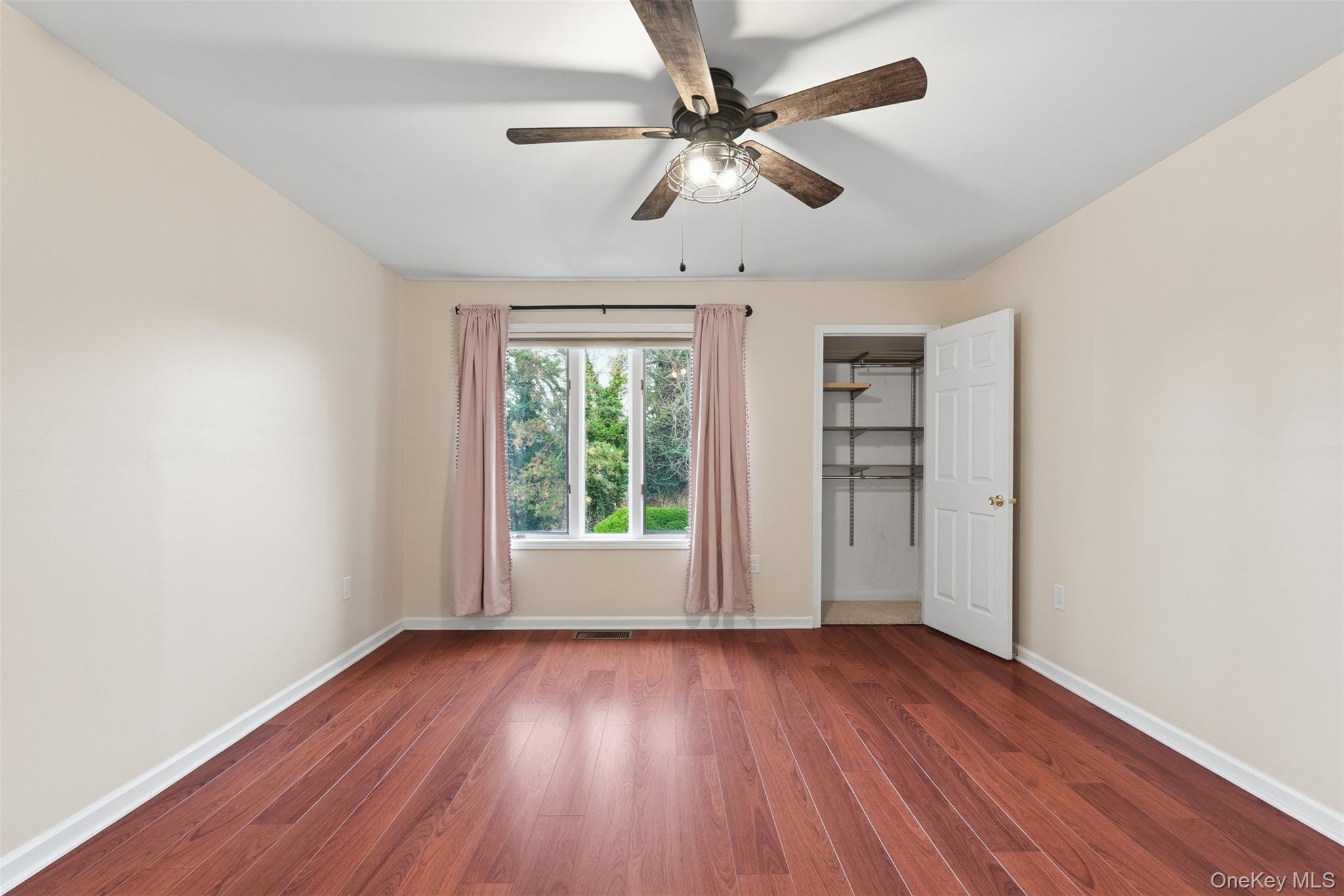 17 Knoll View Ossining, NY 10562 - Photo 19 of 34 an empty room with wooden floor chandelier fan and windows