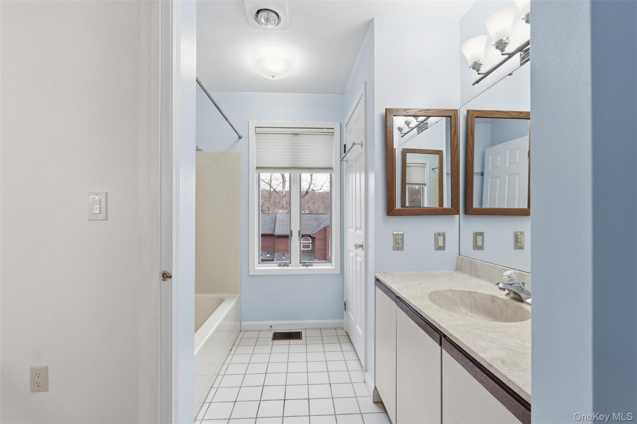 17 Knoll View Ossining, NY 10562 - Photo 25 of 34 a bathroom with a sink a vanity and a mirror