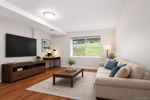 an empty room with wooden floor and window