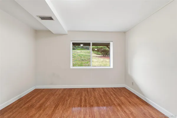 an empty room with wooden floor