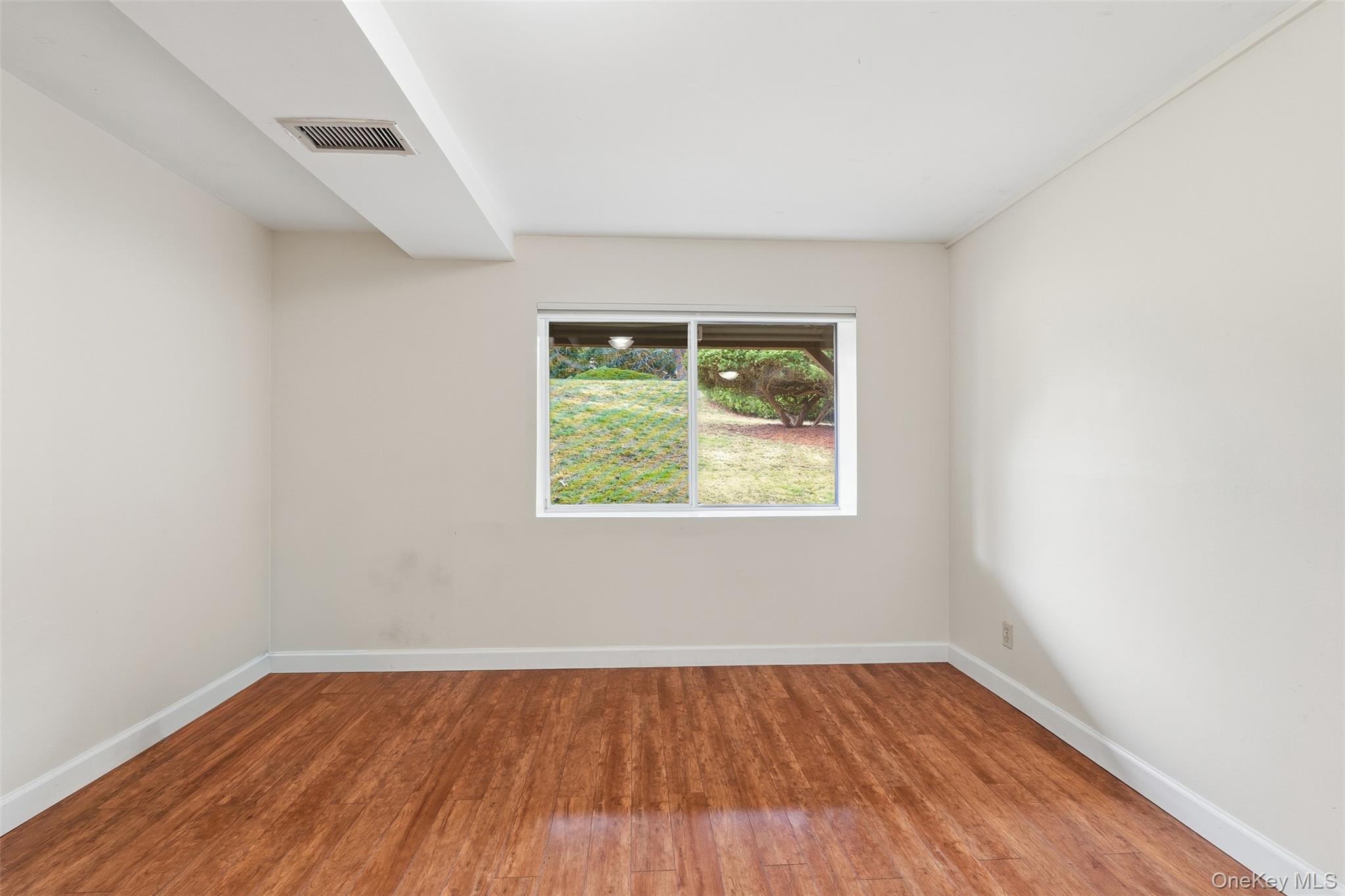 17 Knoll View Ossining, NY 10562 - Photo 29 of 34 an empty room with wooden floor and window