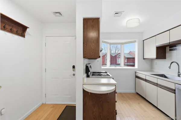 a kitchen with a white stove top oven and refrigerator