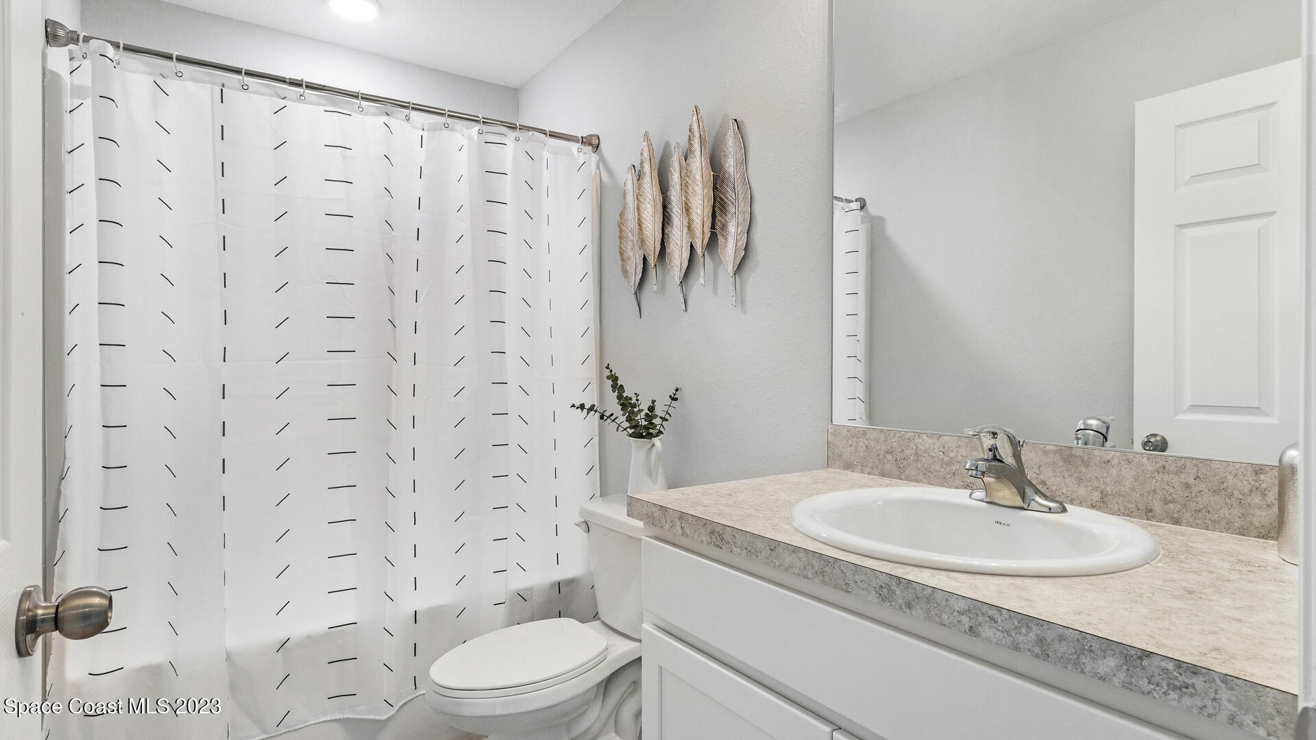 1365 Ran Road Southeast Palm Bay, FL 32909 - Photo 15 of 15 a bathroom with a sink toilet and shower