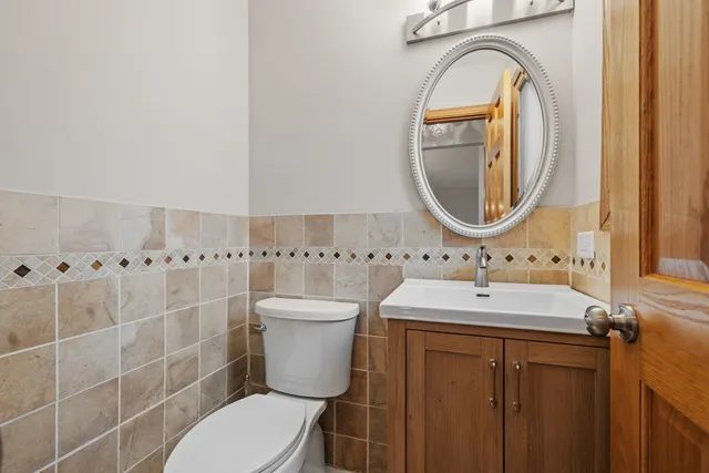 a bathroom with a sink a toilet and a mirror