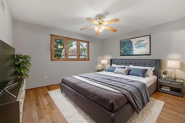 a bedroom with a large bed and a chandelier