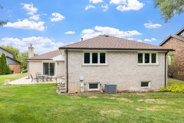 a front view of a house with a garden and yard