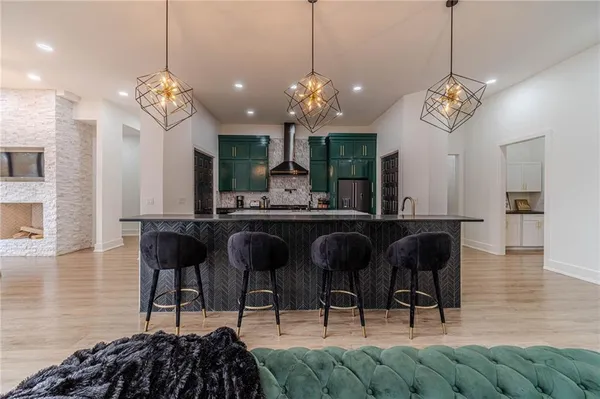 a kitchen with kitchen island granite countertop a sink a counter space appliances and cabinets