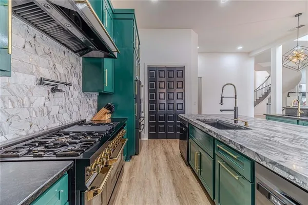 a view of a dining room with furniture wooden floor a fireplace and a chandelier