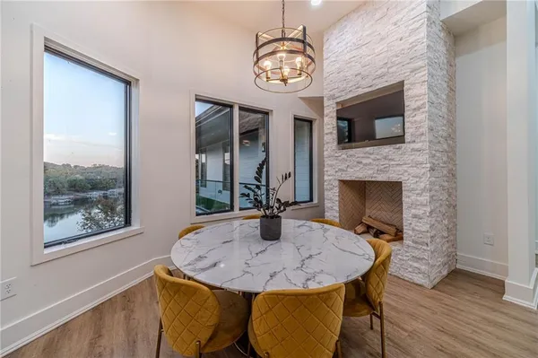 a hallway view with stainless steel appliances granite countertop a sink and wooden floor