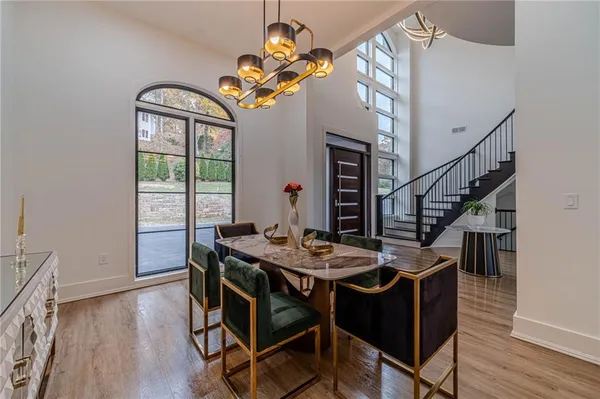 a spacious bedroom with a bed a table and chairs