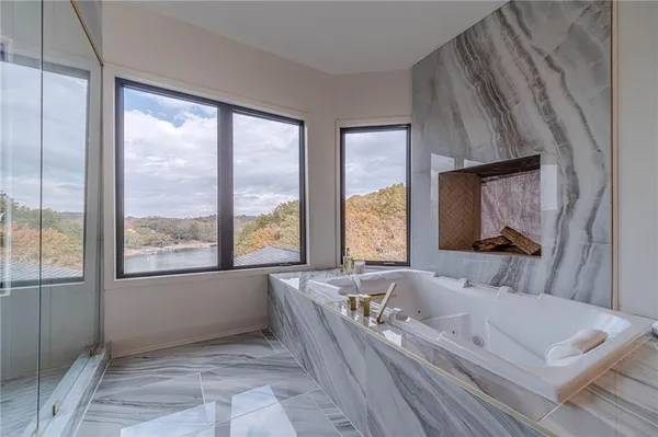 a bathroom with a granite countertop sink a toilet and a mirror