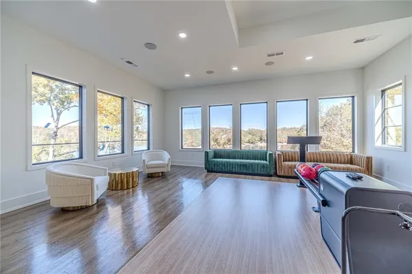 a view of swimming pool with outdoor seating and house in the background