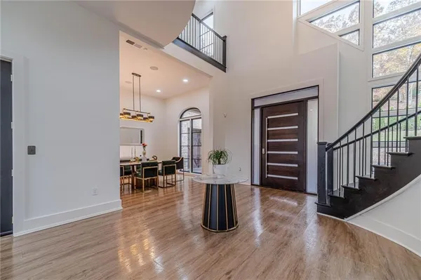 a living room with furniture fireplace and a large window