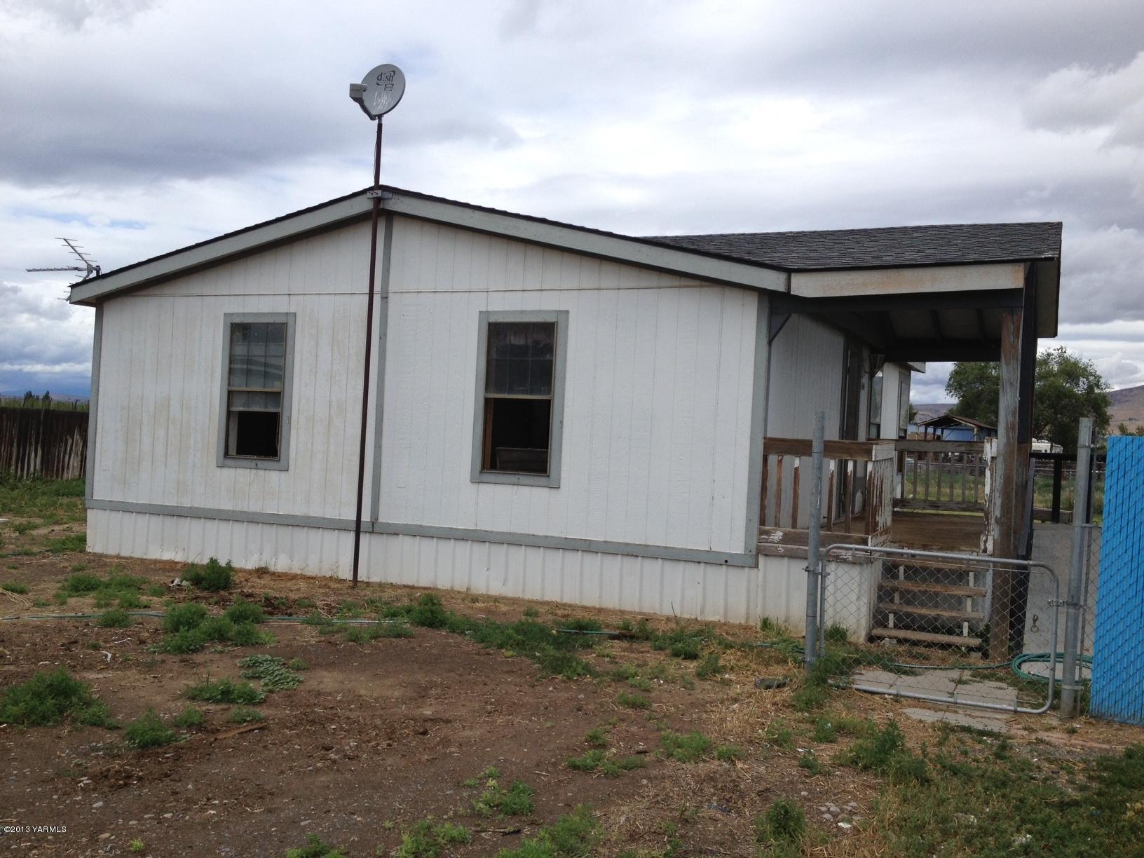 6304 Postma Road Yakima, WA 98901 - Photo 2 of 5 a house with trees in the background