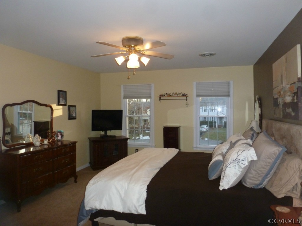 14806 Acorn Ridge Road Midlothian, VA 23112 - Photo 12 of 24 a bedroom with a bed and a flat screen tv