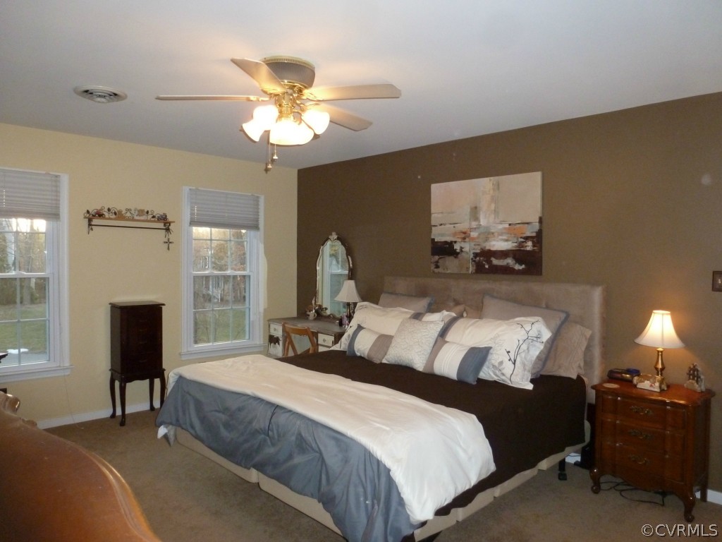 14806 Acorn Ridge Road Midlothian, VA 23112 - Photo 13 of 24 a bedroom with a bed and a chandelier