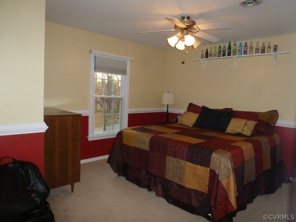 14806 Acorn Ridge Road Midlothian, VA 23112 - Photo 15 of 24 a bedroom with a bed and a chandelier
