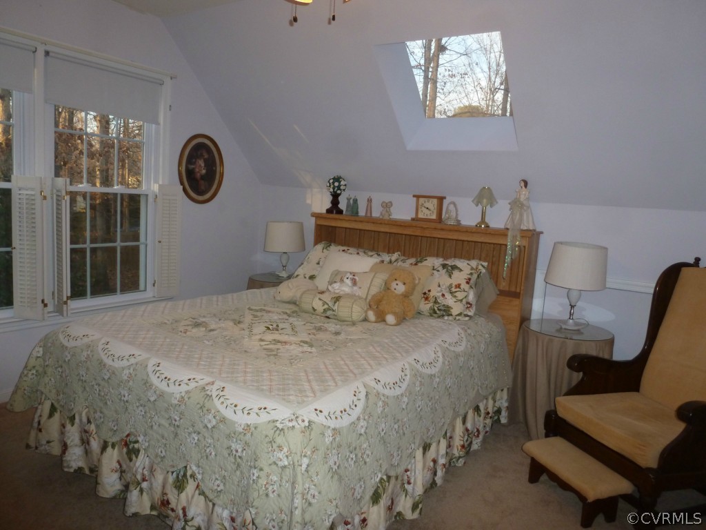 14806 Acorn Ridge Road Midlothian, VA 23112 - Photo 17 of 24 a large bed sitting in a bedroom next to a window and a chair